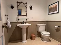 Basement bathroom with pedestal sink and neutral finishes at Brookside Retreat