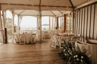 The white tented deck at Chesapeake Bay Foundation Weddings and Events set up for a reception