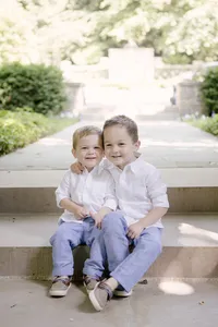 Siblings sitting together on outdoor steps