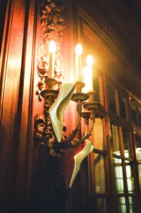ornate gold wall sconce lighting - Photograph of decorative gold architectural wall fixture with warm uplighting detail