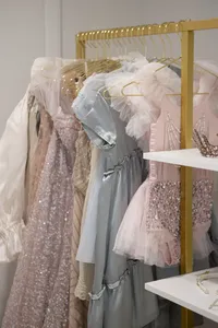 Client dress wardrobe displayed on a rack at Sarah DiCicco's cottage studio