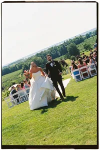 Michigan wedding photographer Grace Wan captures the bride and groom smiling as they exit their wedding ceremony.