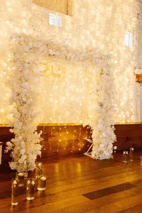 white square wedding floral arch with fairy light backdrop