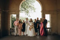 A bride and groom smile with their families next to them, by Detroit elopement photographer Grace Wan.