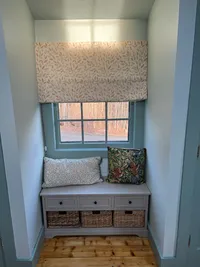 Window seat with patterned shade in the primary bedroom at Brookside Retreat