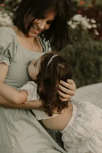 mom hugging toddler daughter