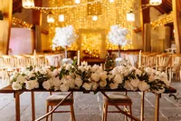 Blossom Tree Wedding Styling ceremony room decor and floral table centrepiece with fairy light backdrop