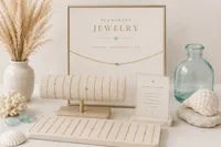 Elegant jewelry display with gold chains, turquoise accents, seashells, glass vase, pampas grass, and a sign reading “Permanent Jewelry.”