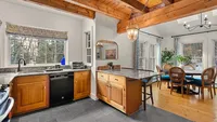 Kitchen and dining area with large windows at Brookside Retreat