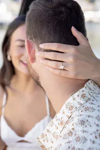 Close-up of a proposal moment with the engagement ring visible
