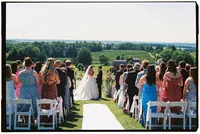 Michigan film wedding photography of a bride and groom during their wedding ceremony as all the guests are standing.