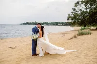 Newlyweds share a kiss on the shores of the Chesapeake Bay in Annapolis
