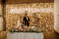The Annie wedding styling collection, colourful floral table arrangements, candles and fairy lights