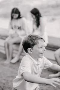 Boy running and laughing, photographed in black and white