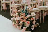 pink floral wedding aisle decor at The Woodman Inn