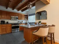 Open kitchen with wood cabinetry and island seating at Brookside Retreat