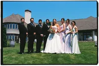 The bride and groom smile and pose with their bridal party, caught on 35mm film by Grace Wan.