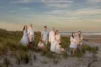 Extended family group portrait standing among the beach dunes