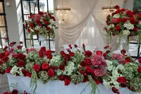 red and burgundy wedding floral table arrangement