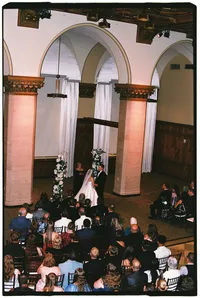 Wedding film photography of a bride and groom during their indoor wedding ceremony.