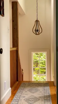 Second-floor hallway with window overlooking the grounds at Brookside Retreat