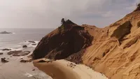 rocky coastal landscape and ocean - Wedding videography still of dramatic seaside rock formations and water views
