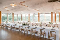 A long family-style table for an indoor-outdoor reception at ccChesapeake Bay Foundation Weddings and Events in Annapolis, MD