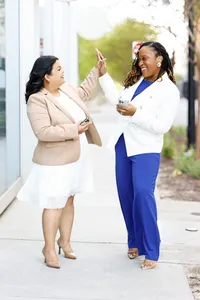 Founders of a minority and women-owned marketing firm high 5ing