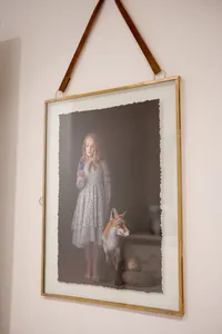 Framed fine art portrait of a girl with a fox, displayed at the cottage studio