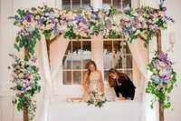 Wedding planner with Weddings & Events by Raina assists bride with her welcome speech