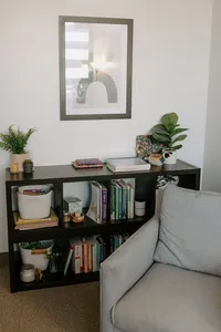 Photo of bookshelf in therapy room with chair