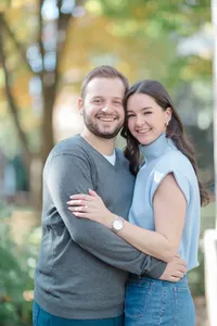 Couple embracing outdoors in soft autumn light during their engagement session