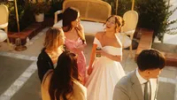 Wedding videography still of newlyweds mingling with guests during cocktail hour