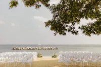 A coastal wedding ceremony in Annapolis, MD on the sand in front of the Chesapeake Bay