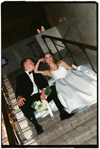 Destination wedding photographer Grace Wan captures an editorial photo of a bride and groom sitting on the stairs.