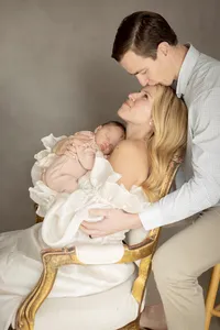 Parents with their newborn baby during a studio portrait session at Sarah DiCicco's cottage studio