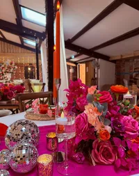 Deighton Lodge wedding styling, bright pink table decor and colourful table centrepiece with candles and disco balls