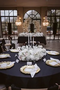 Susie collection black and white venue styling with gold plates and floral arch