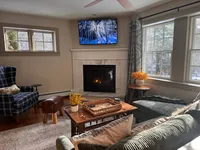 Family room with fireplace and comfortable seating at Brookside Retreat