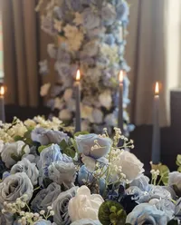 The Alice wedding white and blue floral table decor and ceremoney arch