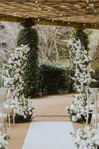 white floral wedding arch by Yorkshire wedding stylists