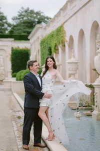 Couple walking through a garden archway during their engagement session