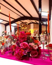 Deighton Lodge wedding styling, bright pink table decor and colourful table centrepiece with candles