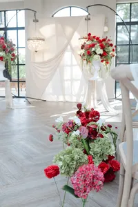 red and burgundy wedding decor inside wedding ceremony room