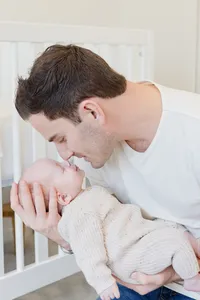 Close-up of father holding his newborn baby