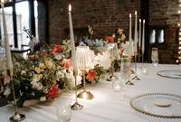 colourful floral wedding table with candles and lighting