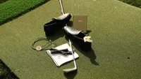 Wedding videography still of black formal shoes and details displayed on lawn