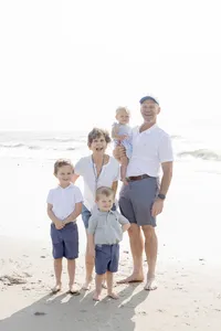 Family group portrait standing together on the beach