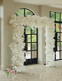 white square wedding floral arch inside wedding venue
