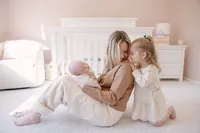 Mother with newborn and toddler during a photoshoot